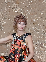 With Pear in Colorful Dress on Sand